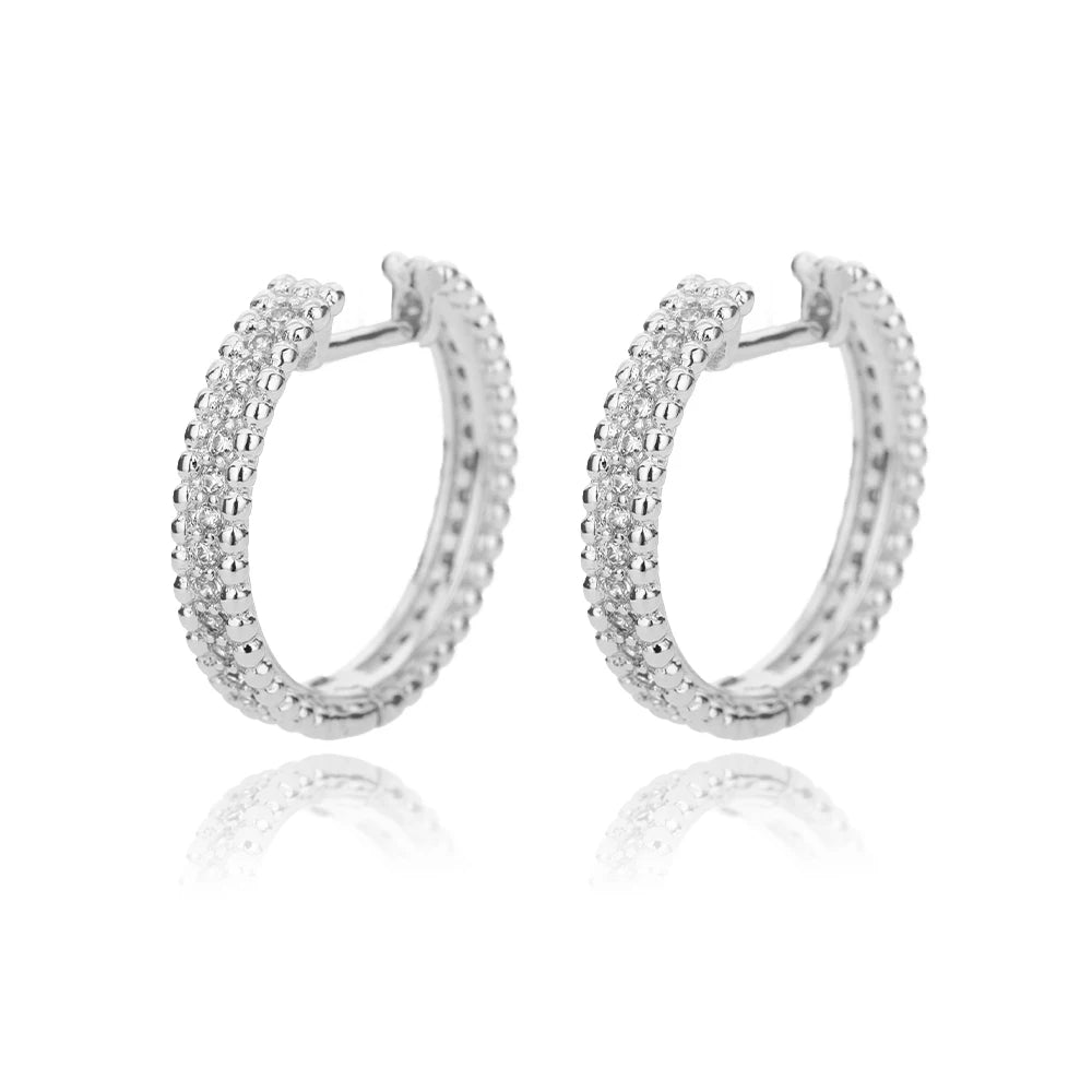 Pair of silver hoop earrings on a white background