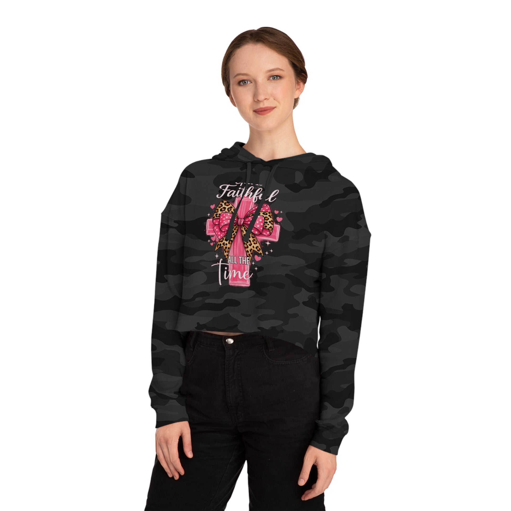 Person wearing a black camo hoodie with a pink design and text on a white background