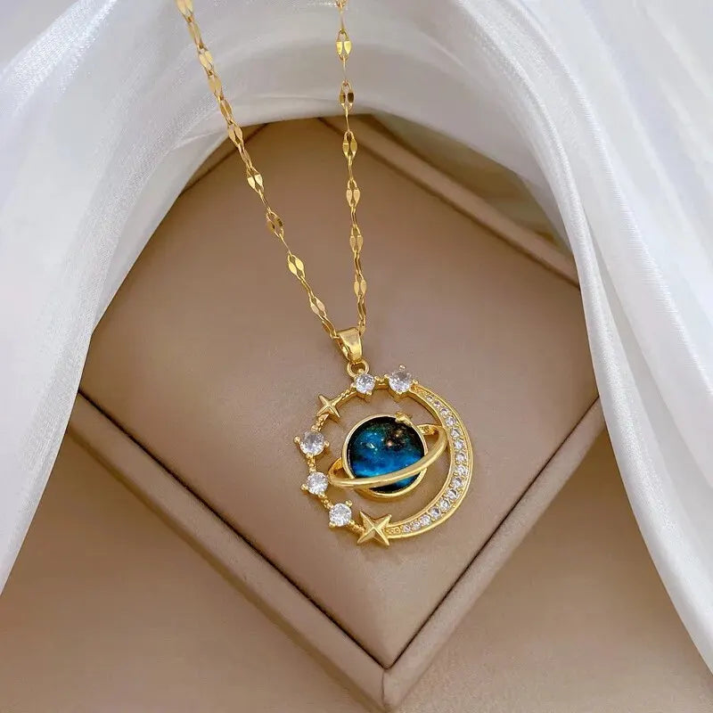 Unknown Product gold necklace with celestial pendant featuring stars and a blue planet centerpiece