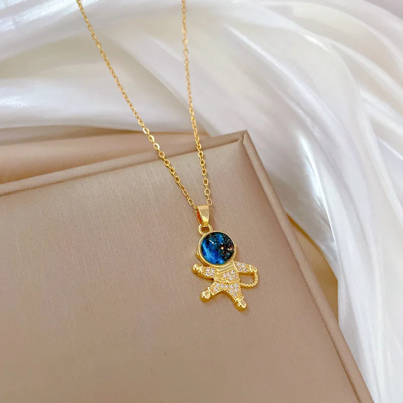 Unknown Product gold astronaut pendant necklace with blue galaxy design on delicate chain
