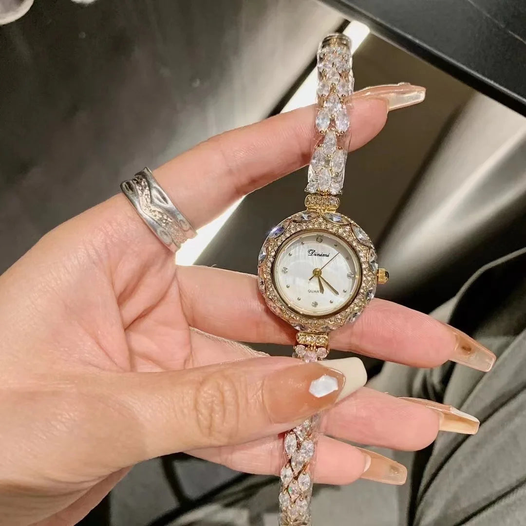 Hand holding a diamond-studded watch with a blurred background