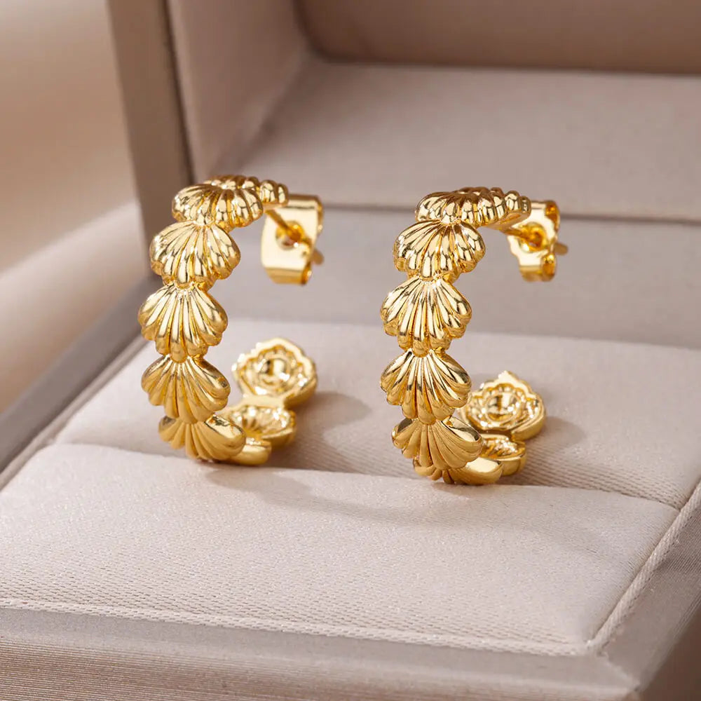 Gold hoop earrings on a soft surface