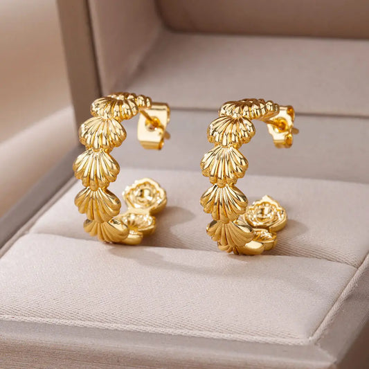 Gold hoop earrings on a soft surface