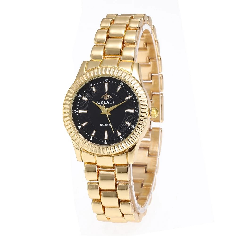 Gold wristwatch with black dial on a white background