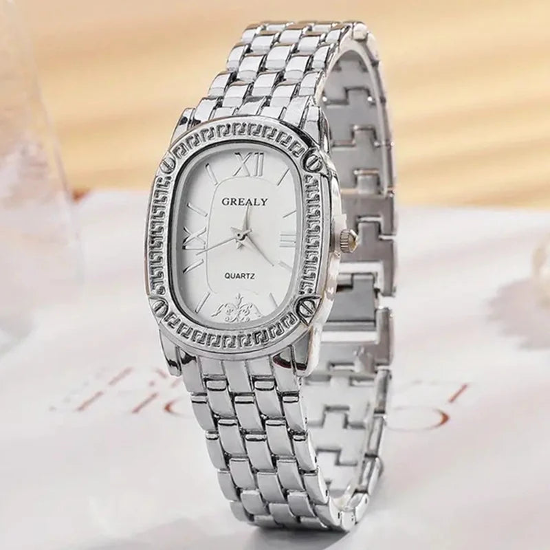Silver watch with a white face on a light background