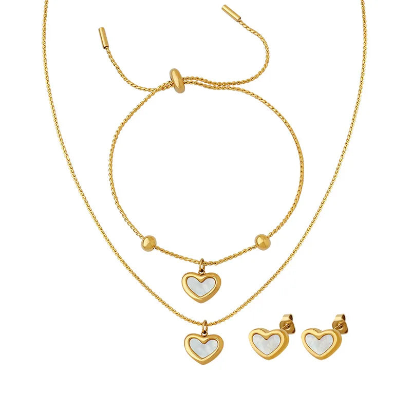 Gold necklace with heart pendants and matching earrings on a white background