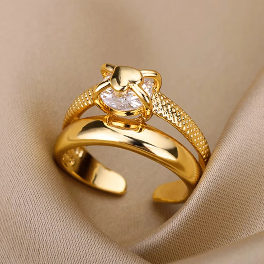 Gold ring with a diamond on a beige fabric background