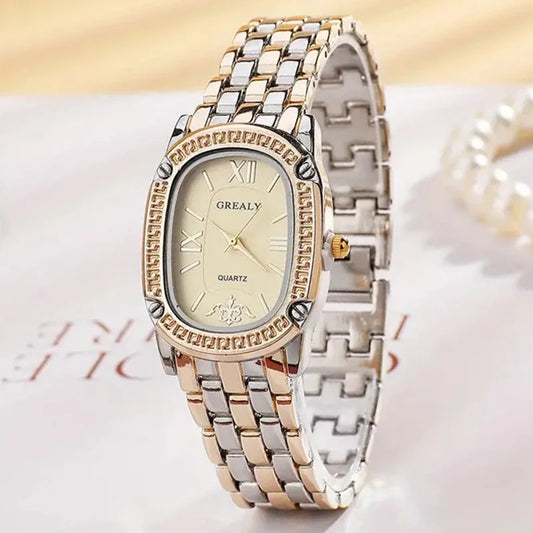 Two-tone watch with gold and silver band on a light background