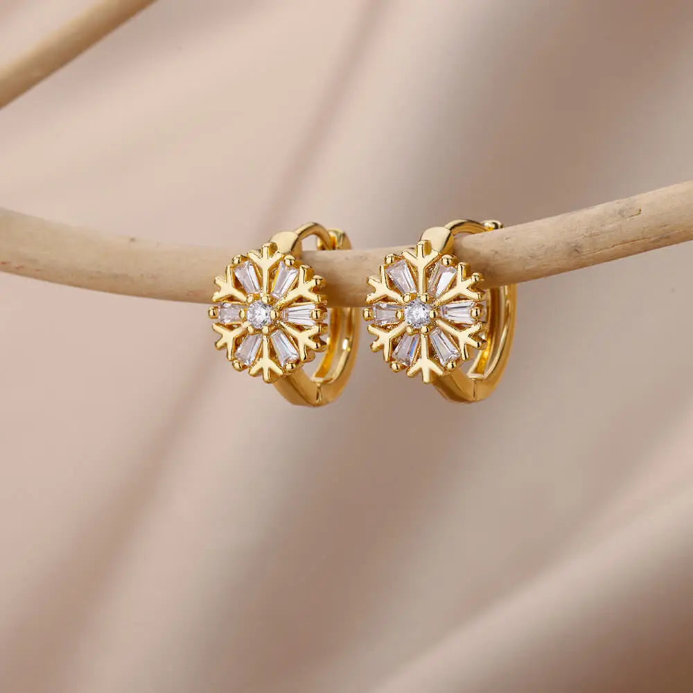 Gold hoop earrings with diamond accents on a beige background