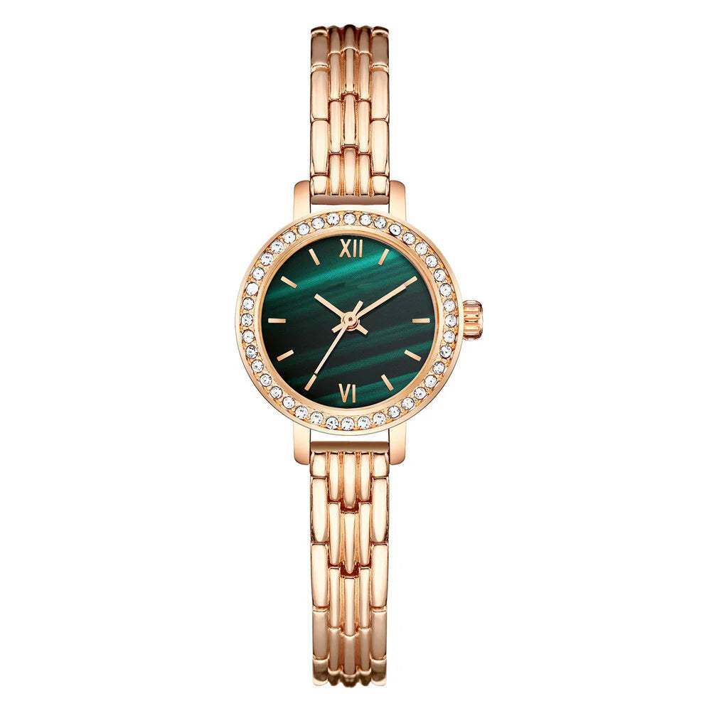 Rose gold watch with green face on a white background