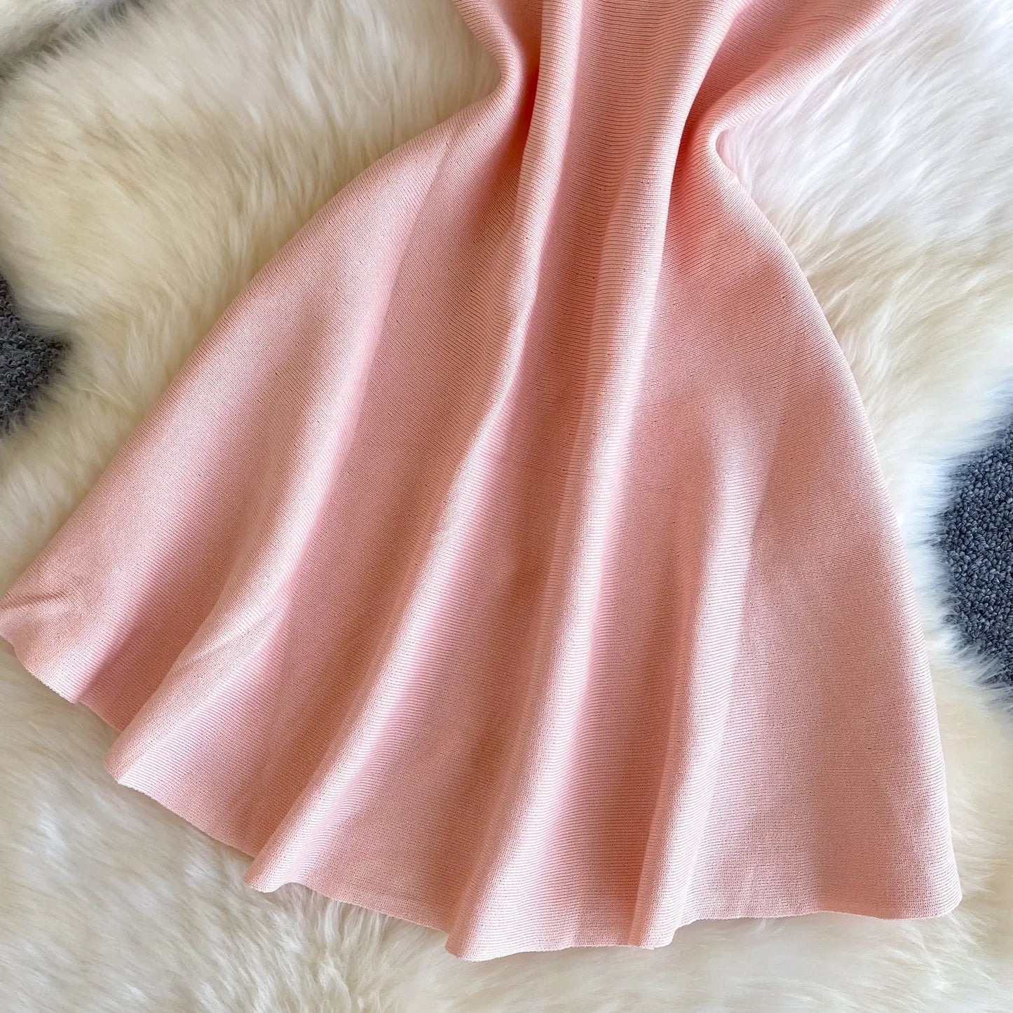 Pink fabric on a fluffy white surface