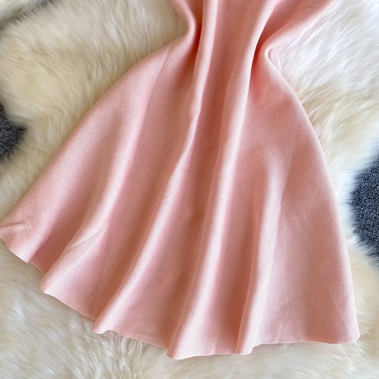 Pink fabric on a fluffy white surface