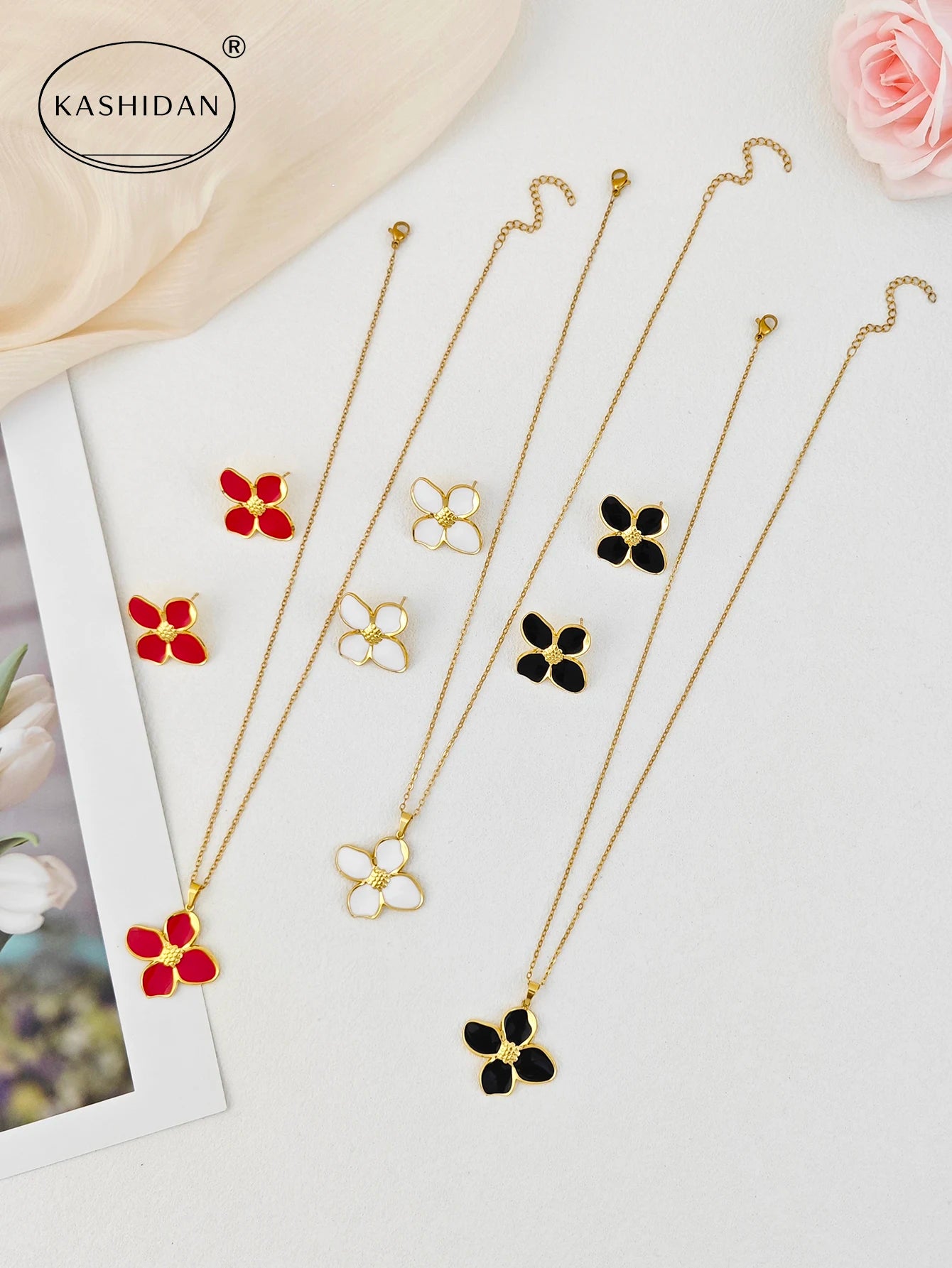 Set of necklaces with floral pendants on a white background, featuring the brand 'Kashidan'.