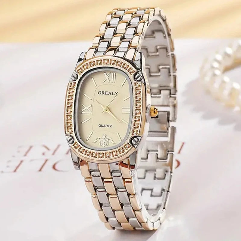 Two-tone watch with gold and silver band on a light background