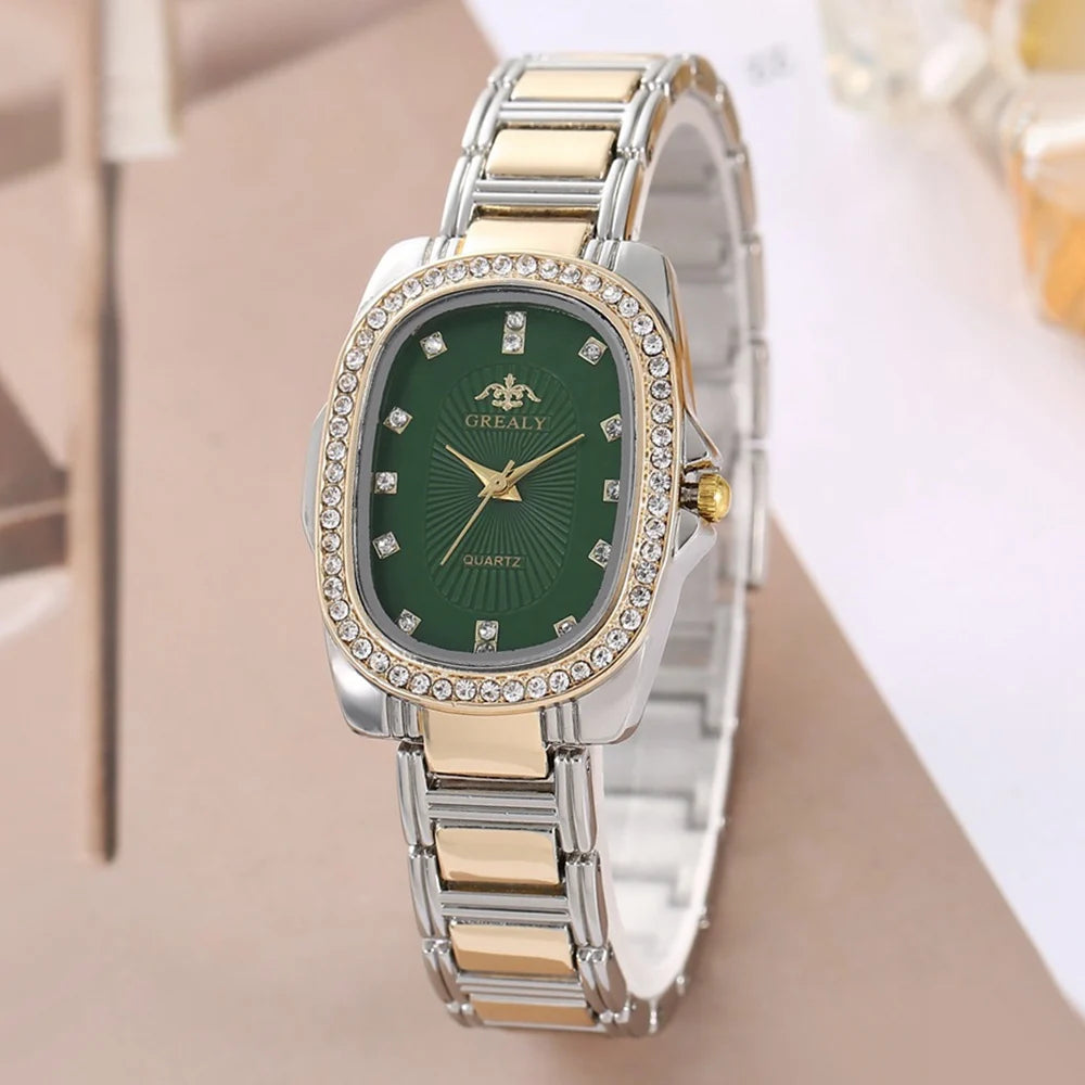 Two-tone watch with a green face on a beige surface