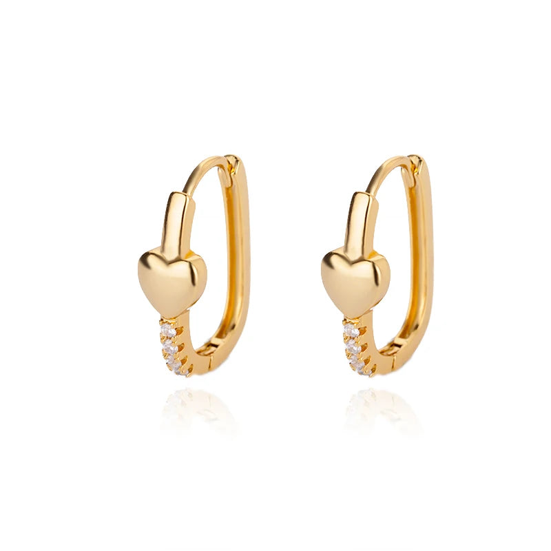 Gold heart-shaped hoop earrings on a white background